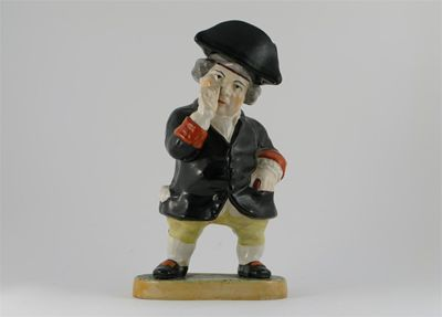 A Staffordshire standing snuff taking Toby his tricorn hat forming