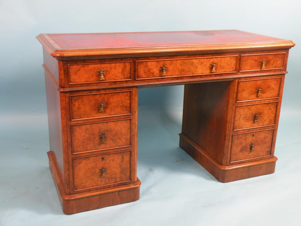 A Victorian burr walnut pedestal desk rectangular top with a