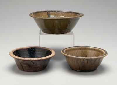Three alkaline glaze bowls one with flattened rim visible turning