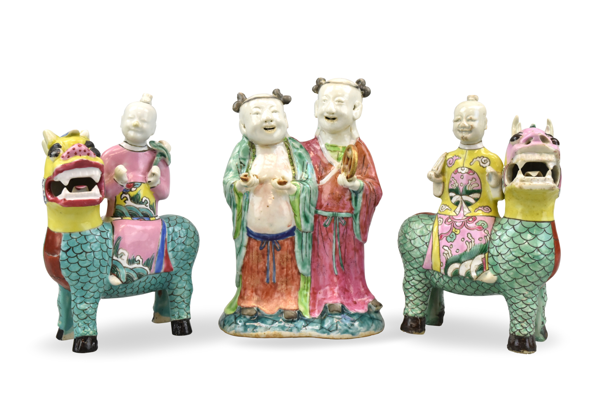 Three Chinese famille rose figures two smiling figures riding a