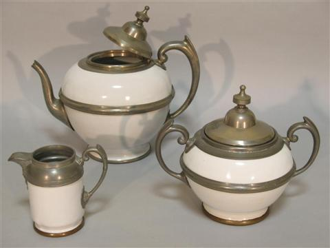 CONTINENTAL METAL MOUNTED STONEWARE TEA SERVICE Including a teapot and