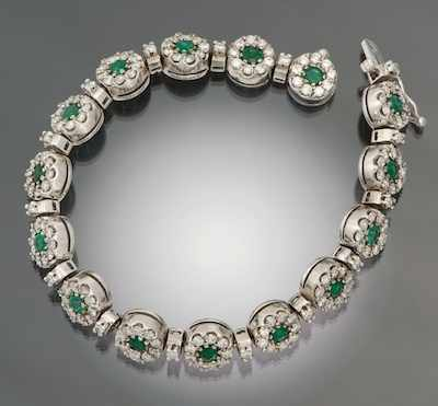 A Ladies Diamond and Emerald Floret Design Bracelet 14k white