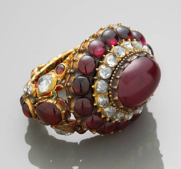 A garnet ruby diamond and enamel ring mounted in eighteen