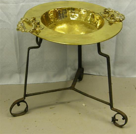 Brass twin handled circular dish on wrought iron tripod stand