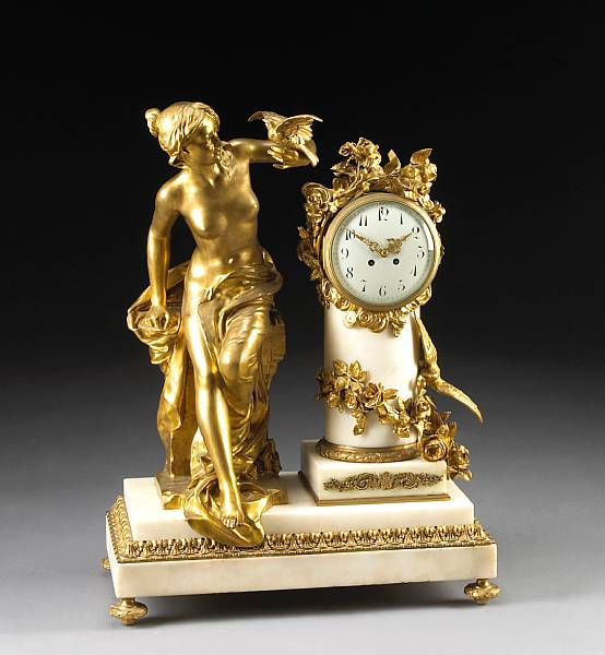 A Belle poque gilt bronze and marble figural clock after