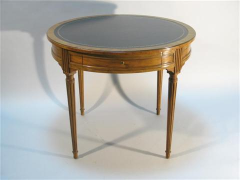 BAKER WALNUT AND LEATHER CENTER TABLE The circular tooled leather