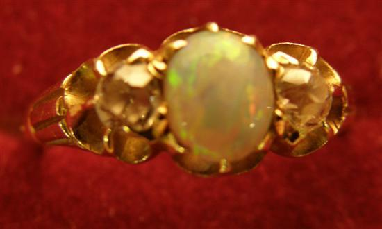Opal and diamond three stone ring set with a centre