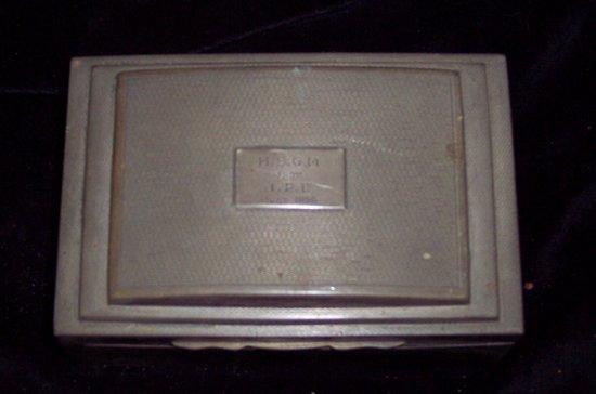 A cigarette box marked HBGM from IPE June 1955 marks