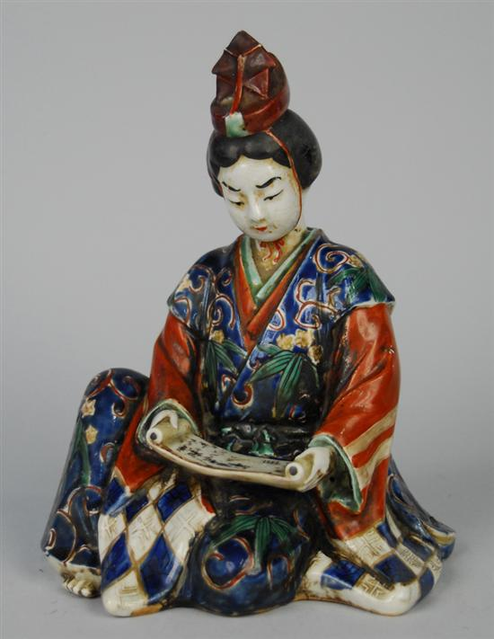 JAPANESE SEATED POLYCHROME GLAZED FIGURE OF A WOMAN READING SCROLL