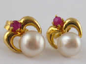 A pair of yellow metal tests 18 carat gold ruby