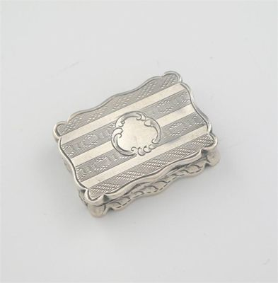 A Victorian vinaigrette decorated with striped engine turning vacant cartouche