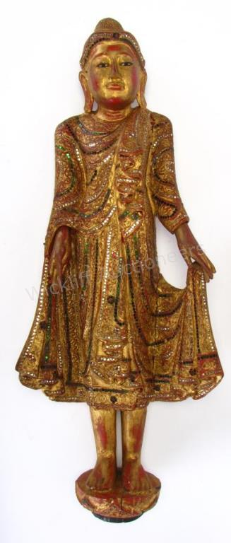 A carved solid wood Buddha figure painted with green white