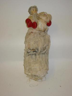 A novelty cotton reel doll made up of various reels
