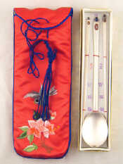 A Chinese white metal untested long spoon and chopsticks with