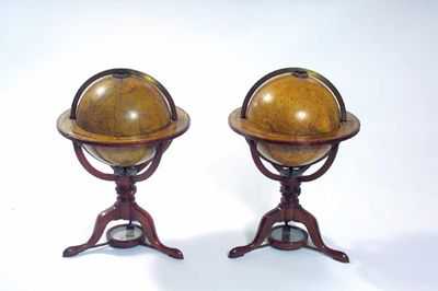 A pair of Regency table globes sold by W S