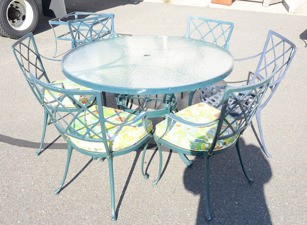 Eleven piece outdoor lot to include round glass top table