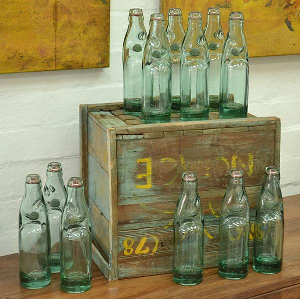 INDUSTRIAL WOODEN CRATE CONTAINING ONE DOZEN GLASS BOTTLES INDUSTRIAL WOODEN