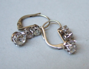 A pair of diamond set three stone pendant earrings each