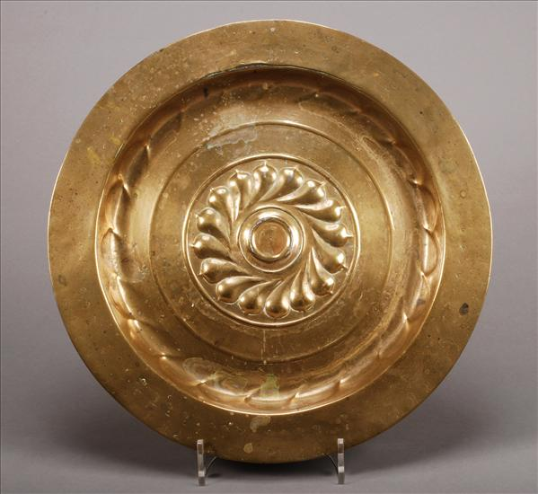 A Nuremberg brass alms dish late 17th century the centre