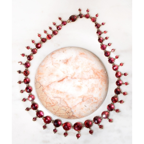 A French foiled garnet necklace 19th c of 37 faceted