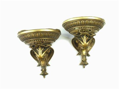 A pair of gilt composition brackets with mask and scroll