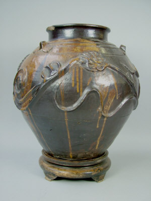 A Chinese pottery vase of ovoid form with applied flower