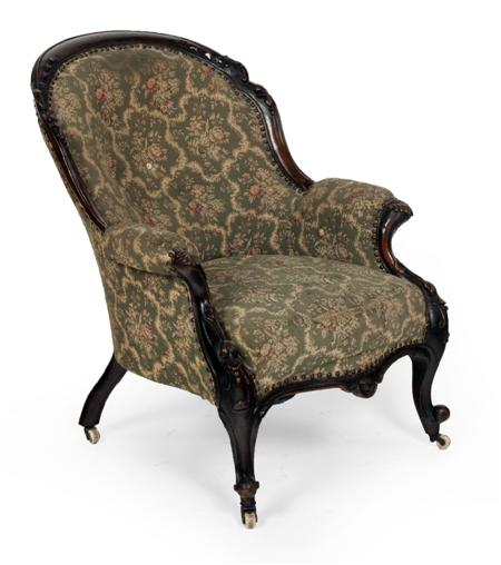 A Victorian mahogany framed button back arm chair floral carved