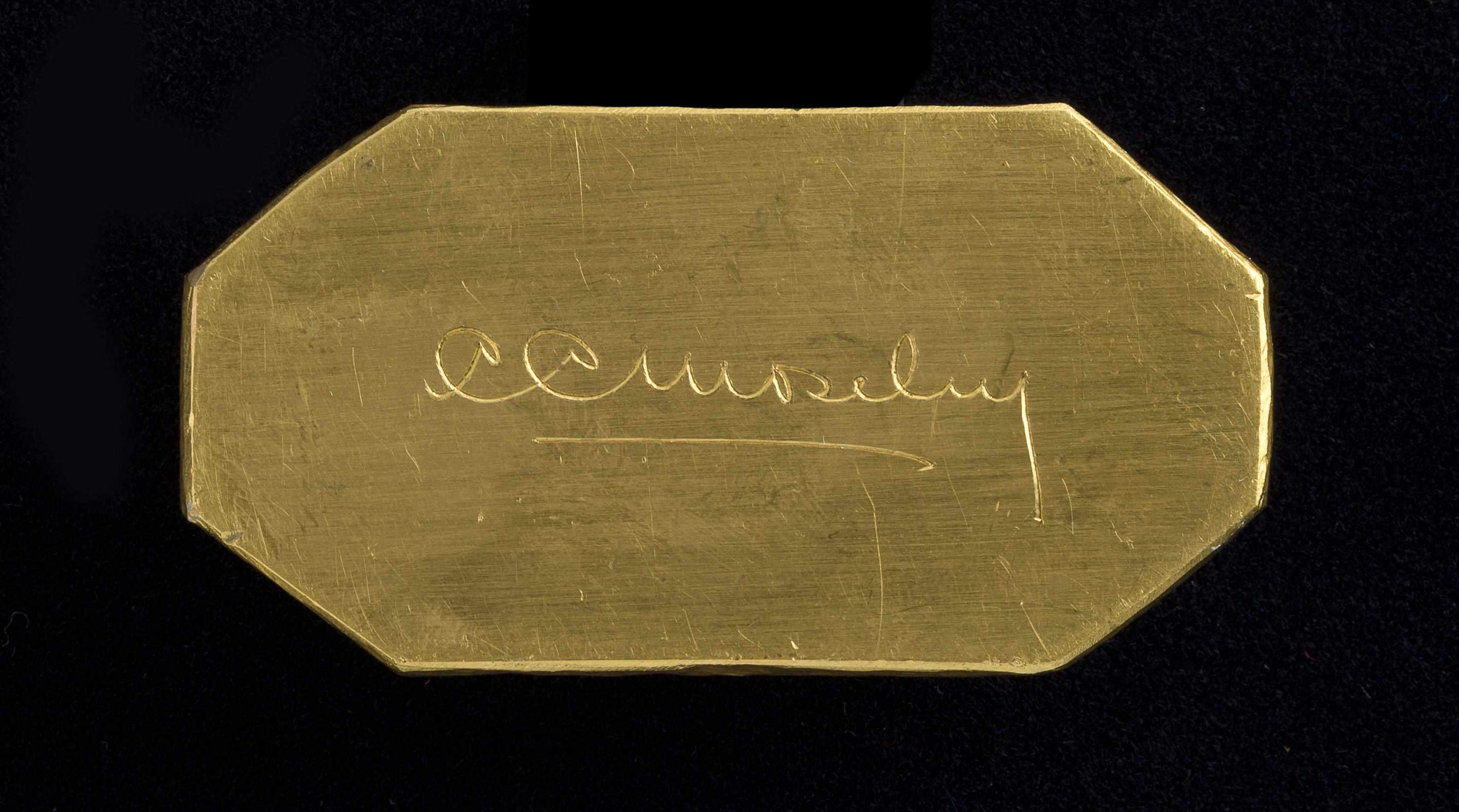 CORLISS C MOSELEY S GOLD PAPERWEIGHT Paperweight in the form