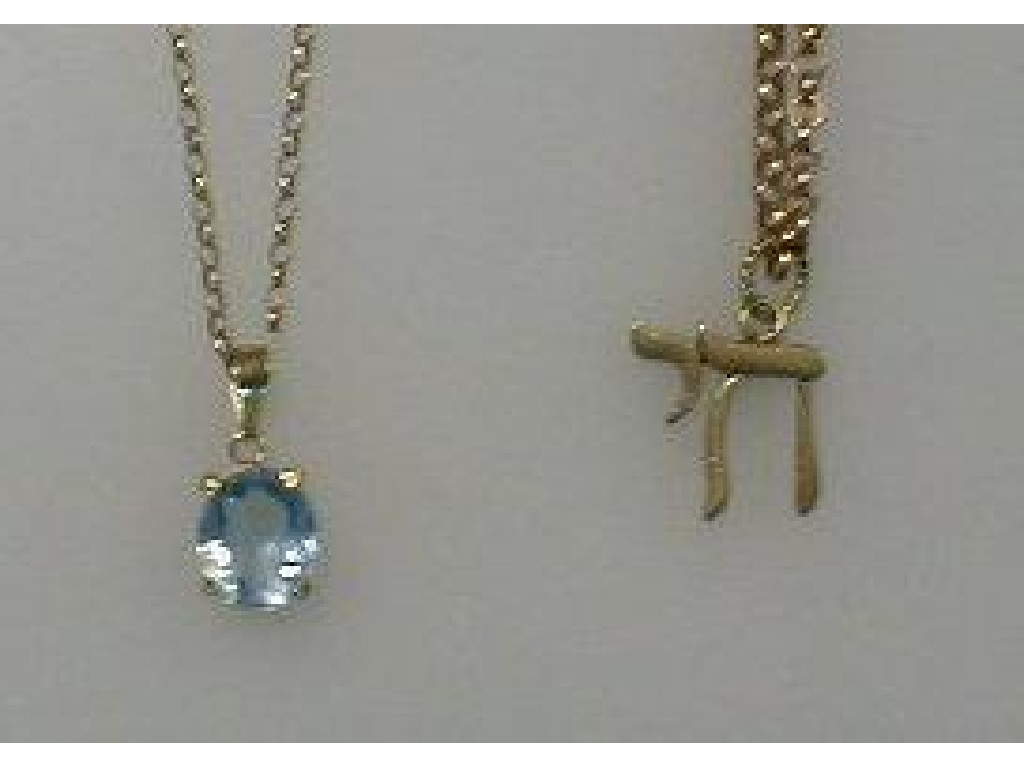 A pale blue stone set pendant on belcher chain and