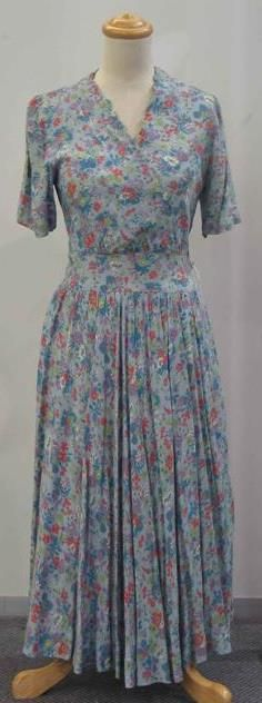 Day dress in blue floral printed cotton with cross over