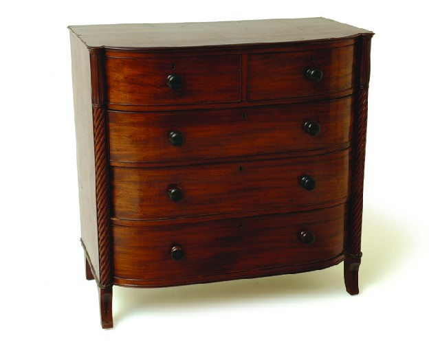 A GEORGE IV MAHOGANY OF DRAWERS The bowed rectangular top