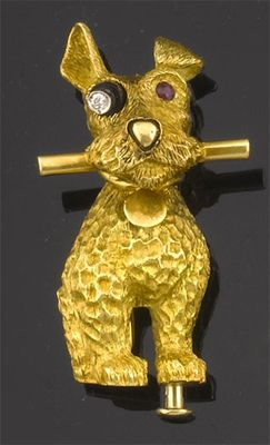 A gold dog brooch by Cartier The sitting dog holding