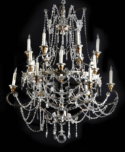 A Continental Neoclassical silvered iron wood and cut glass eighteen