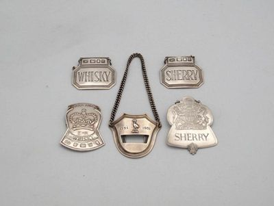 A collection of five modern silver wine labels comprising A