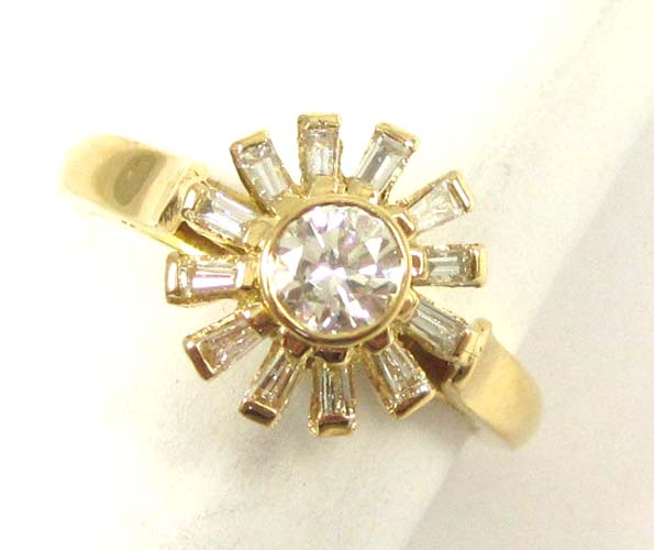DIAMOND AND FOURTEEN KARAT GOLD RING with twelve baguette cut