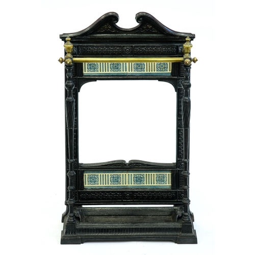 A Victorian tiled cast iron stick stand with brass rails