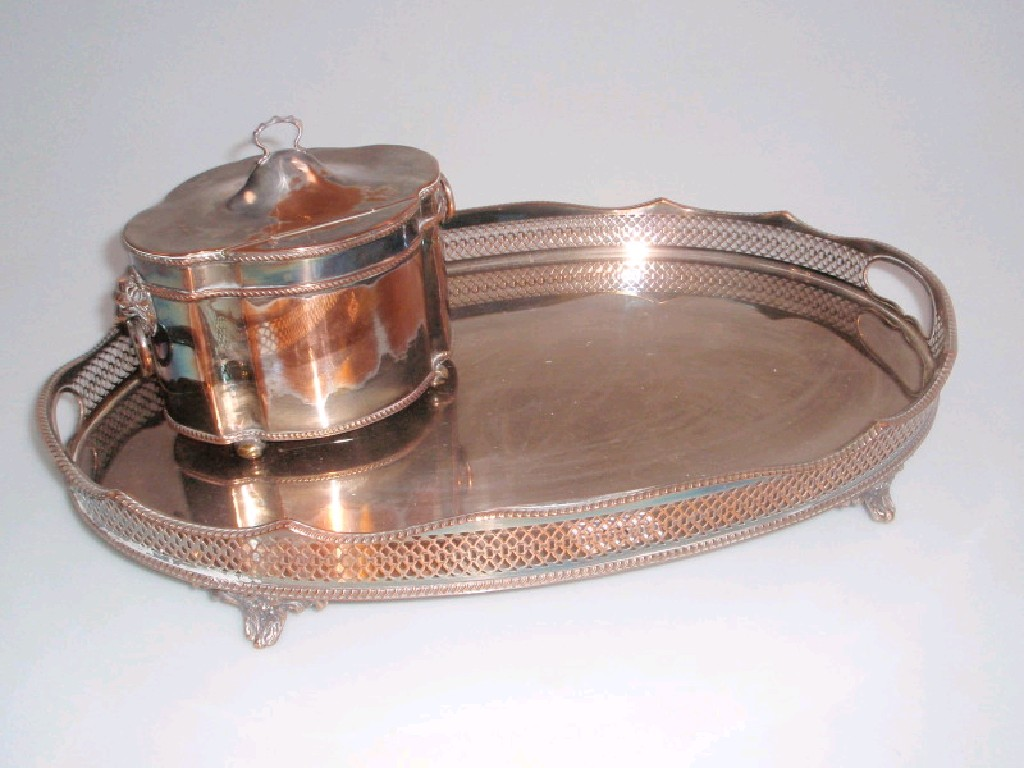 An oval electroplate on copper tea caddy and similar tray