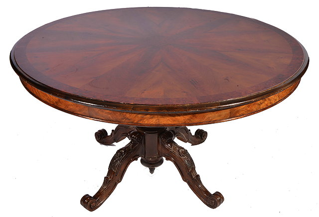 A CIRCULAR WALNUT DINING TABLE with quartered veneered top with