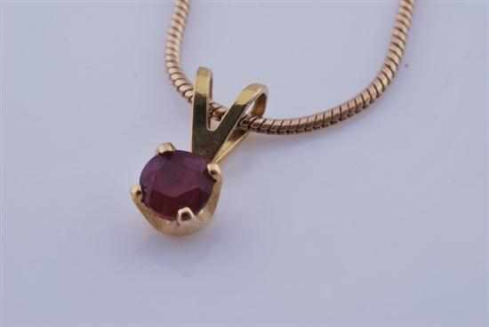 A SMALL RUBY PENDANT WITH CHAIN STAMPED 14CT GOLD