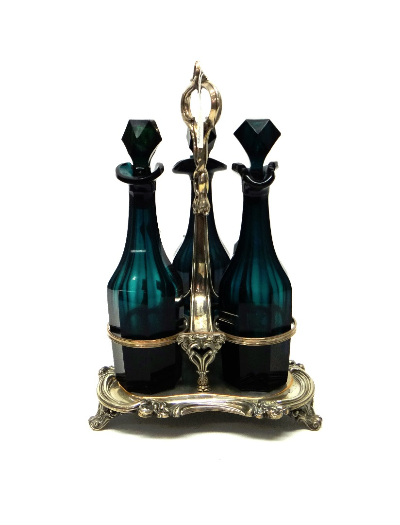 A Sheffield plated three bottle decanter stand the triform base