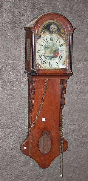 A German parcel gilt and parcel ebonized oak wall clock