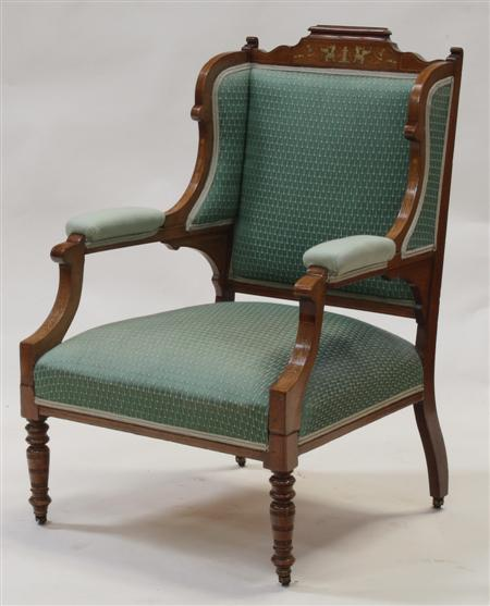 A Victorian rosewood and inlaid wing back armchair the shaped