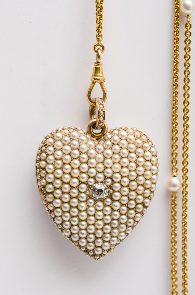 GOLD AND CULTURED PEARL NECKLACE Stamped 14k suspending a heart