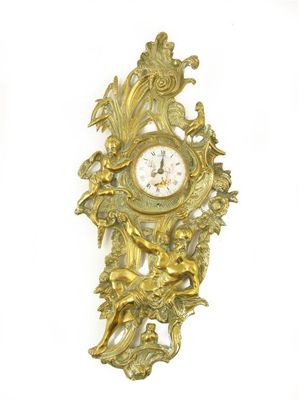 A cast gilt brass cartel clock with a watch movement