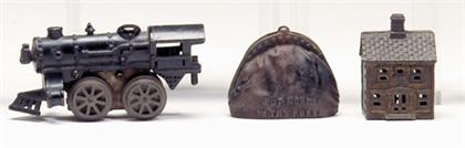 Two cast iron banks and cast iron train engine toy