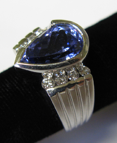TANZANITE DIAMOND AND FOURTEEN KARAT WHITE GOLD RING WITH APPRAISAL