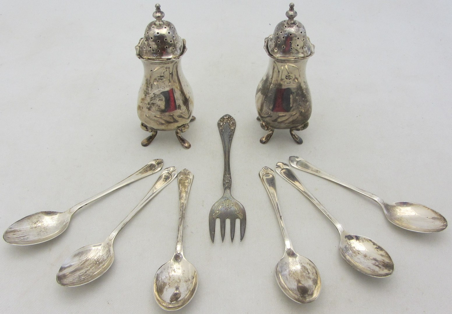 Silver comprising a pair of pepperettes each raised on four