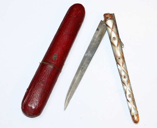 A CONTINENTAL MOTHER OF PEARL AND GOLD MOUNTED TRAVELLING FOLDING