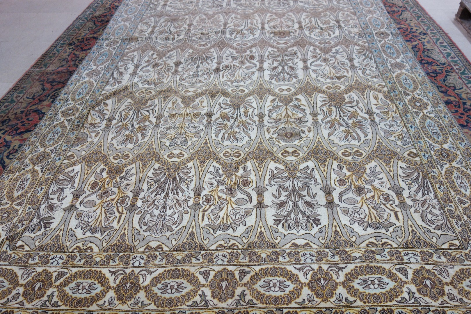 A Qum carpet Persian the ivory field with ovals of