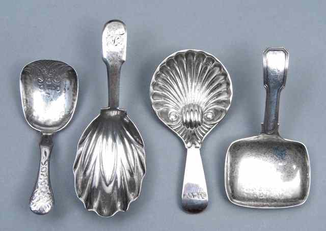 A GEORGE III SILVER CADDY SPOON with a pressed leaf